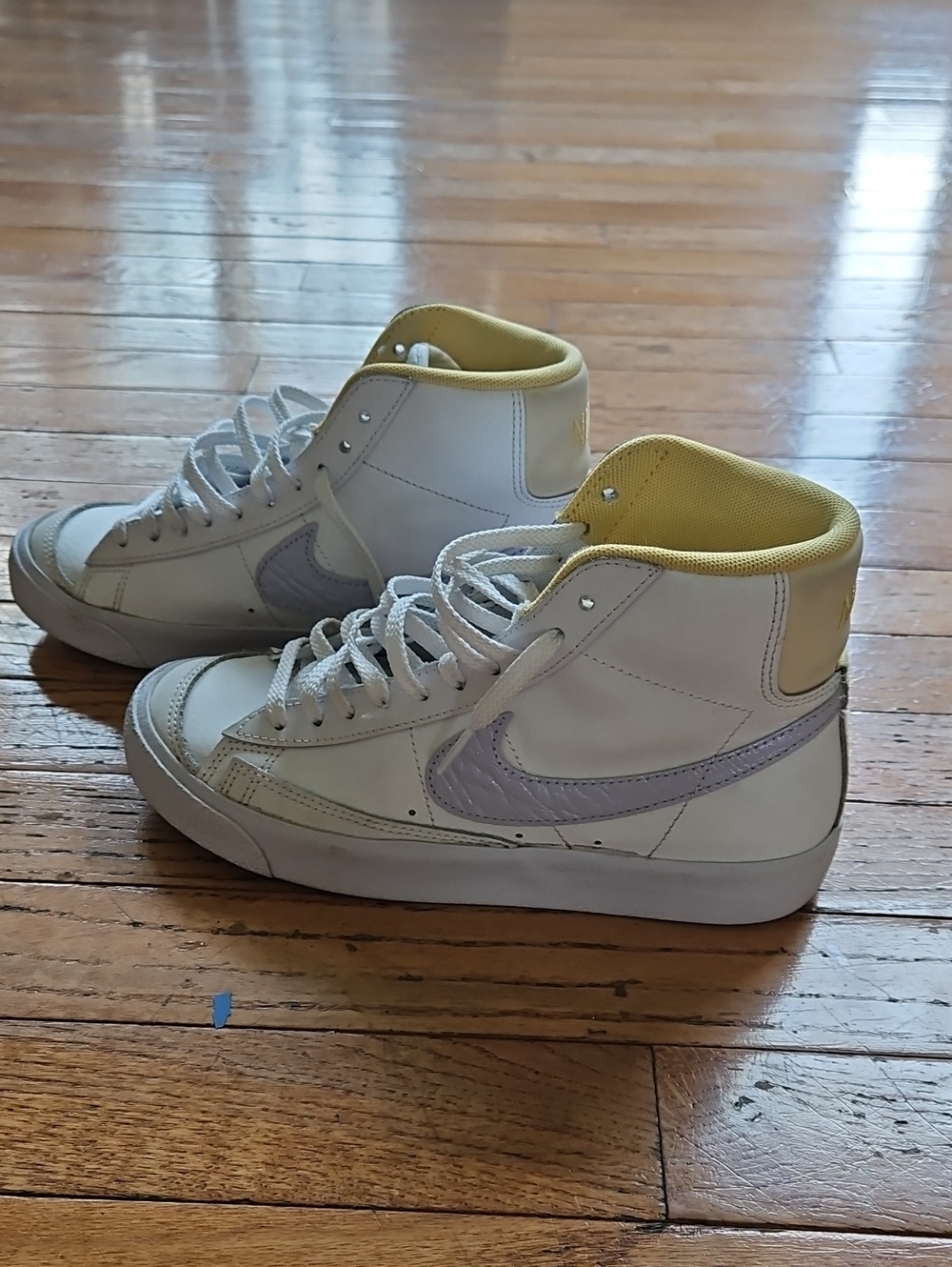 Nike White High-Top Sneakers with Light Purple Swoosh and Yellow Lining